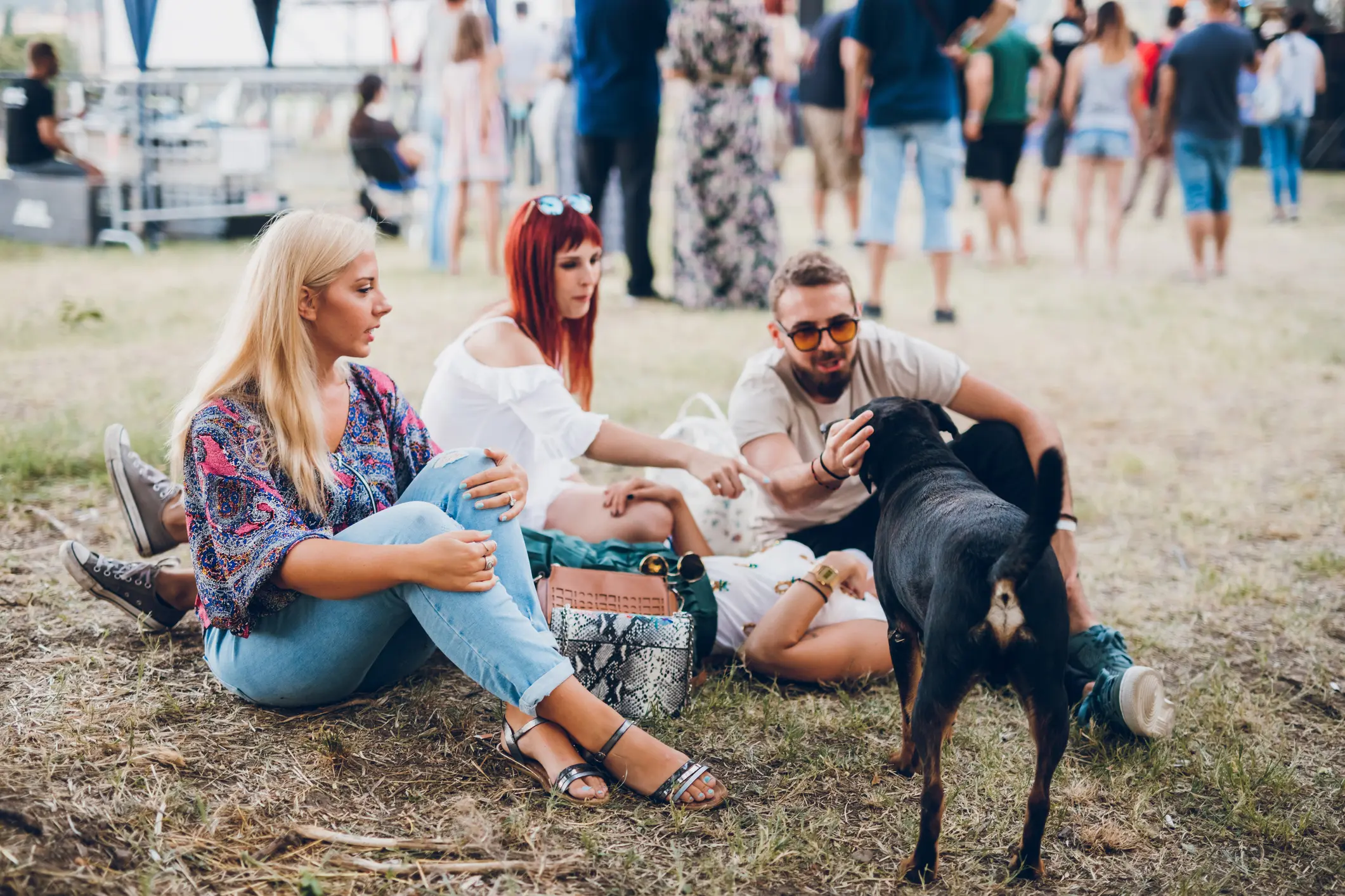 People sitting outdoors with a dog.