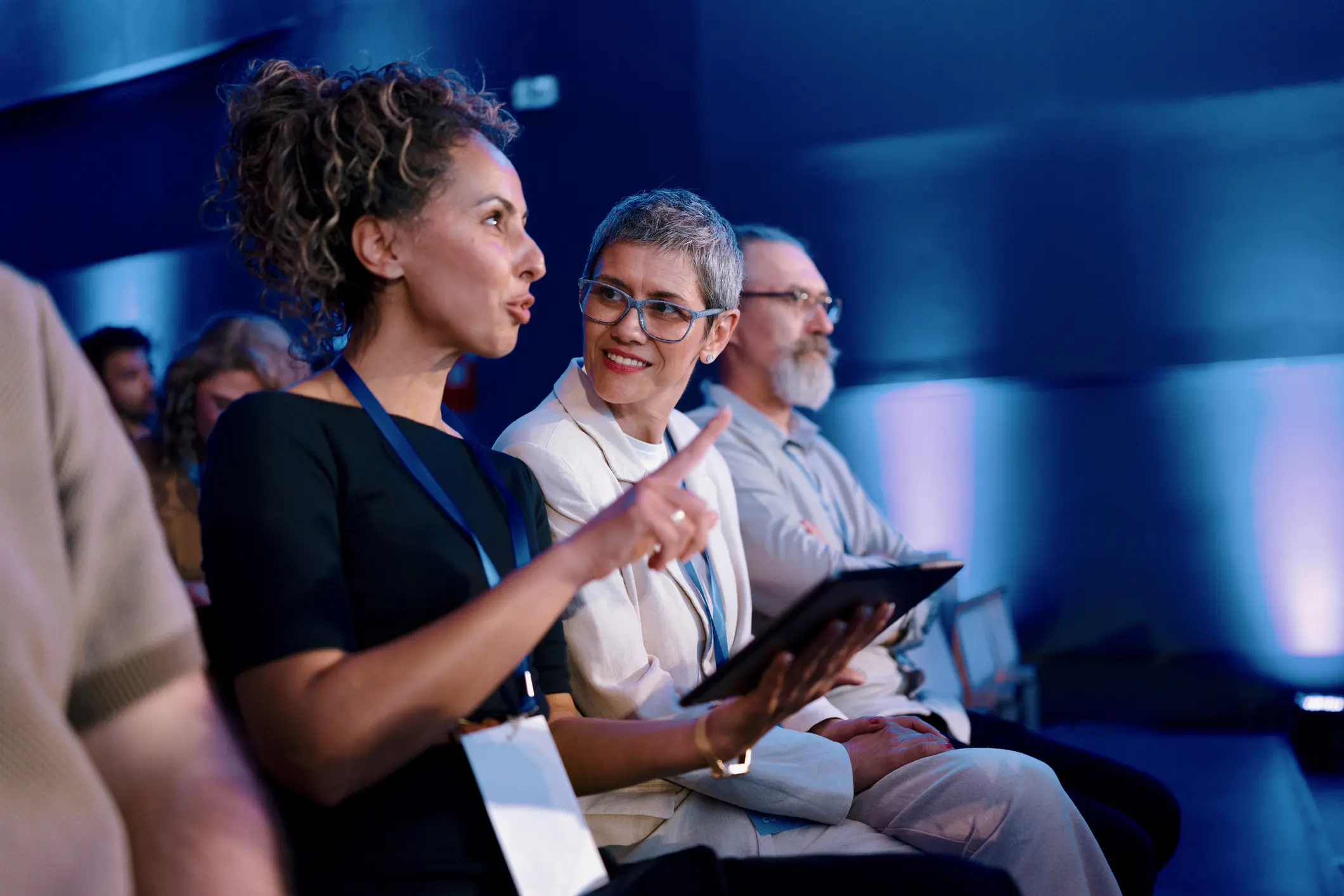 People conversing at a conference or event.