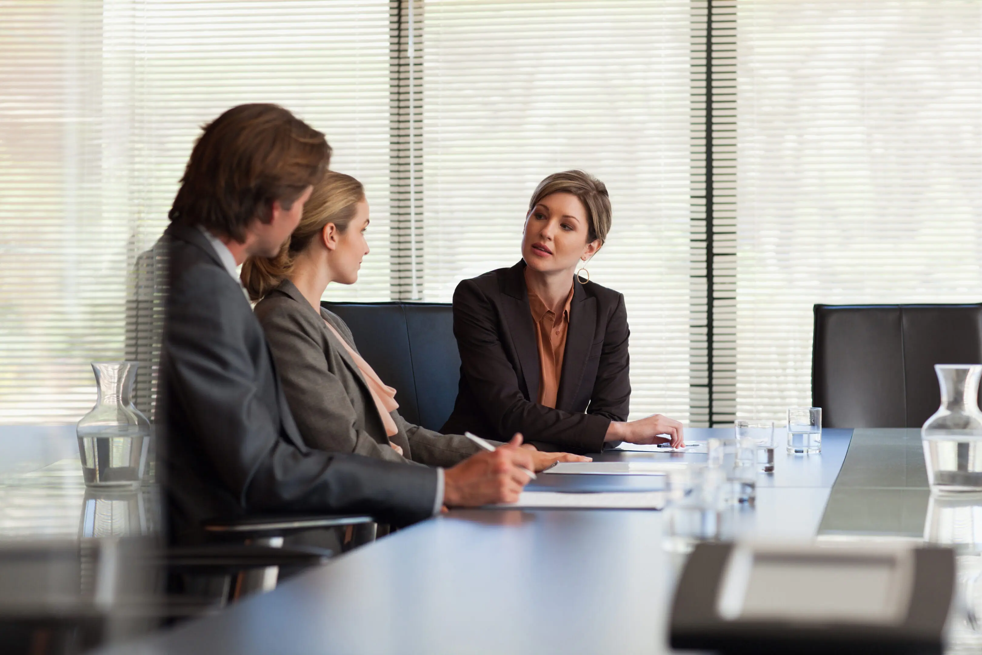 Business people reviewing paperwork in conference room
